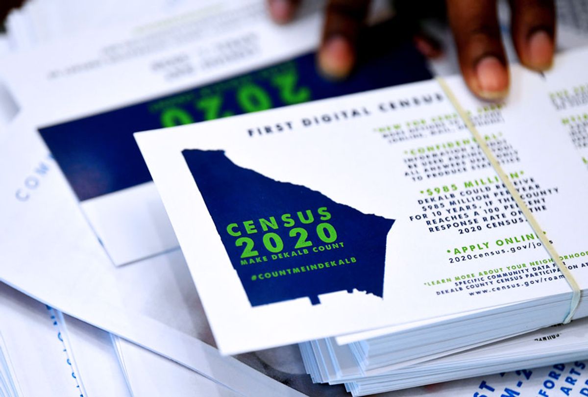 A worker gets ready to pass out instructions on how to fill out the 2020 census during a town hall meeting in Lithonia, Ga.  (AP Photo/John Amis)