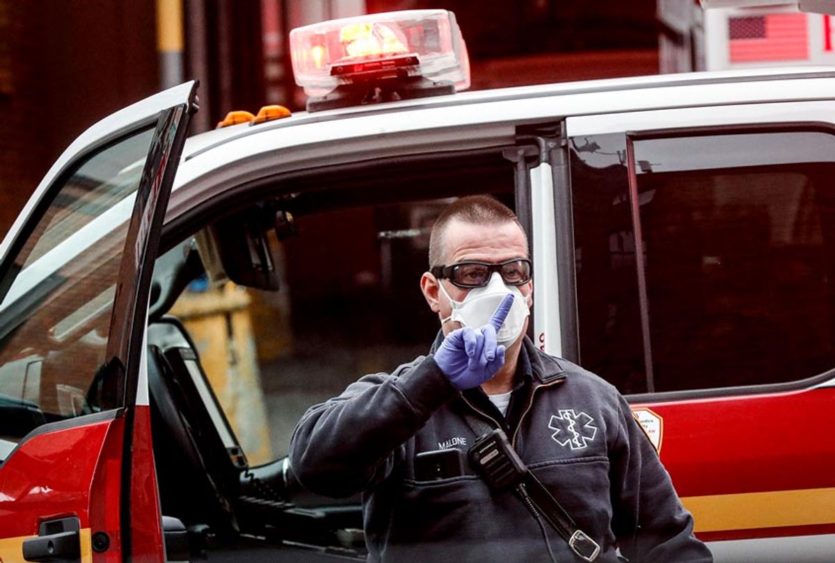 An FDNY medical worker wears personal protective equipment outside a COVID-19 testing site at Elmhurst Hospital Center (AP Photo/John Minchillo)