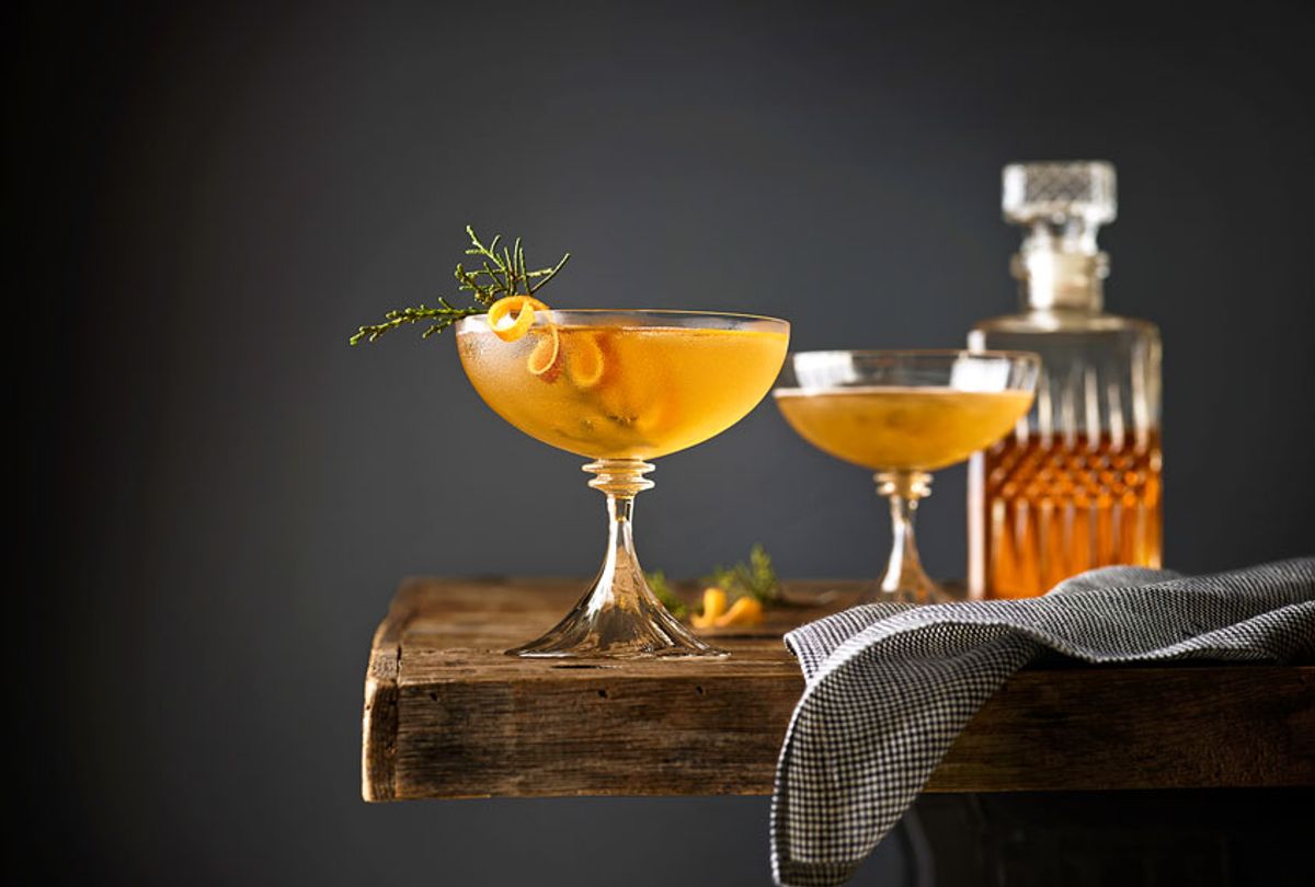 Manhattan cocktails garnished with Juniper on a table with whiskey decanter in the background. (Getty Images/Annabelle Breakey)