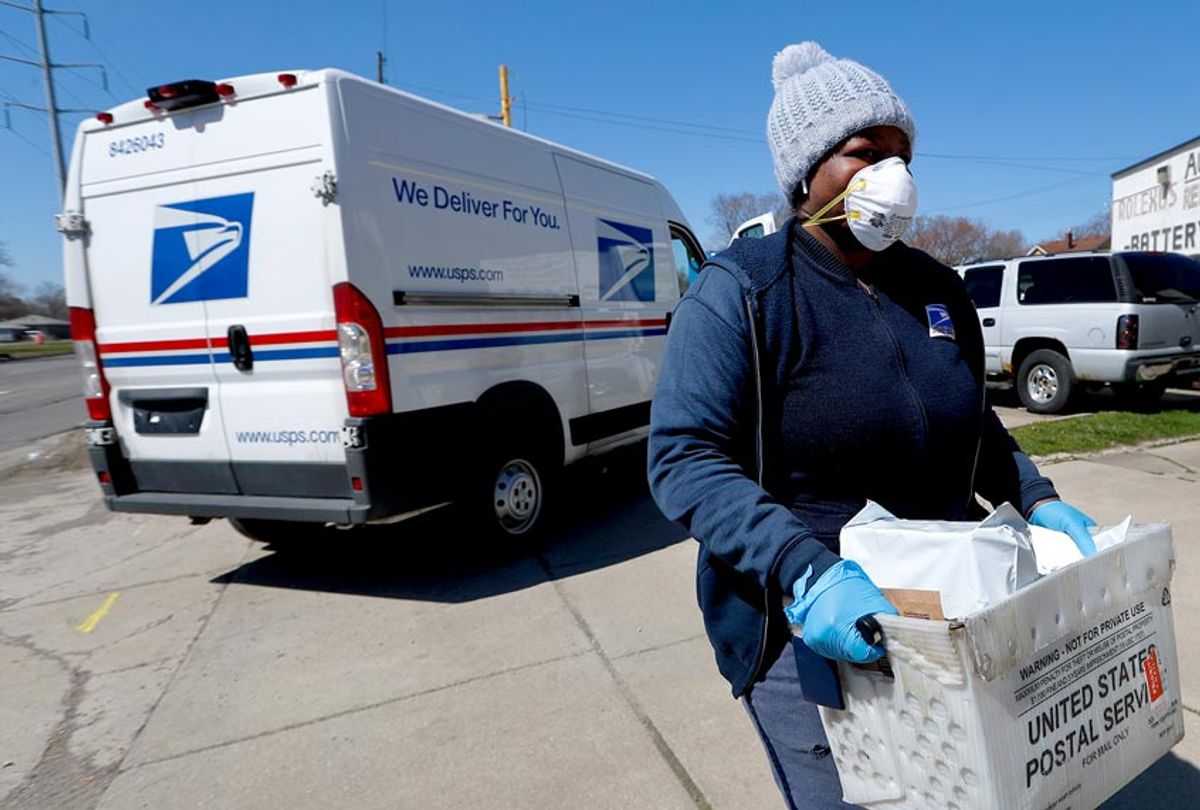 A United States Postal worker makes a delivery with gloves and a mask (AP Photo/Paul Sancya)