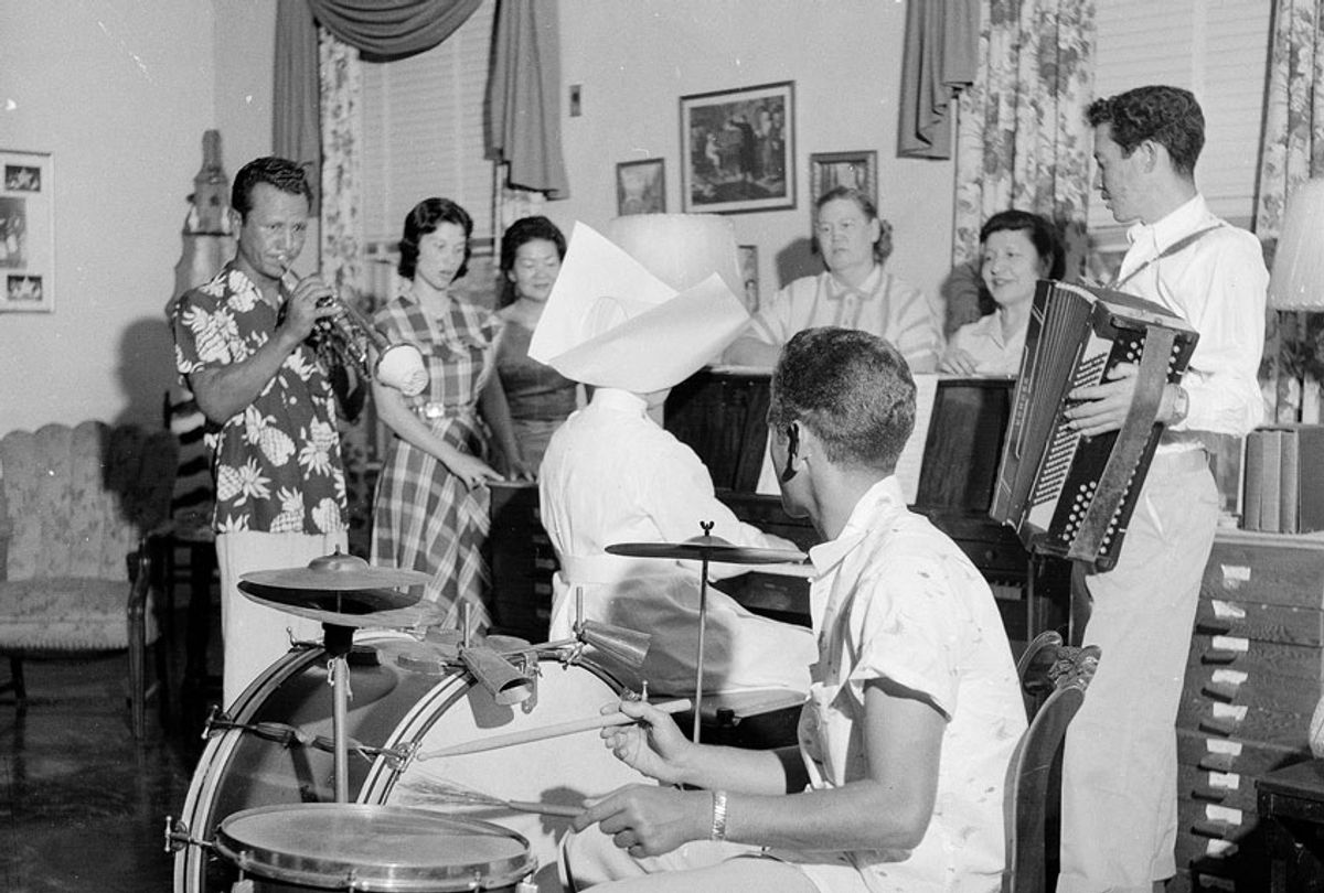 Patients at the US Public Health Service Hospital in Carville, Louisiana, enjoying a musical evening. The hospital is for leprosy sufferers and is run by nuns, one of whom is playing the piano whilst patients play drums and accordion. (Three Lions/Getty Images)