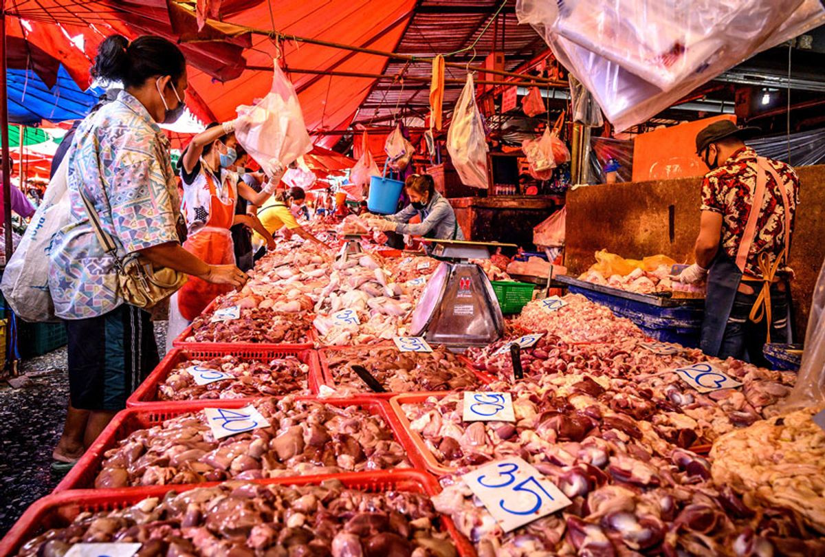 A woman buys meat at a wet market despite fears of the spread of the COVID-19 coronavirus in Bangkok (MLADEN ANTONOV/AFP/Getty Images)