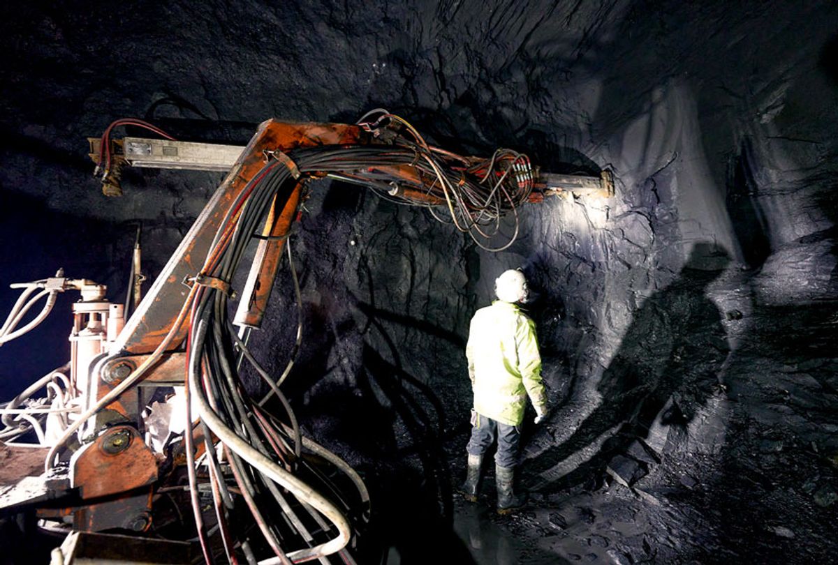 Using a hydraulic hammer, miners mine roof slate in an underground pit (Thomas Frey/picture alliance via Getty Images)