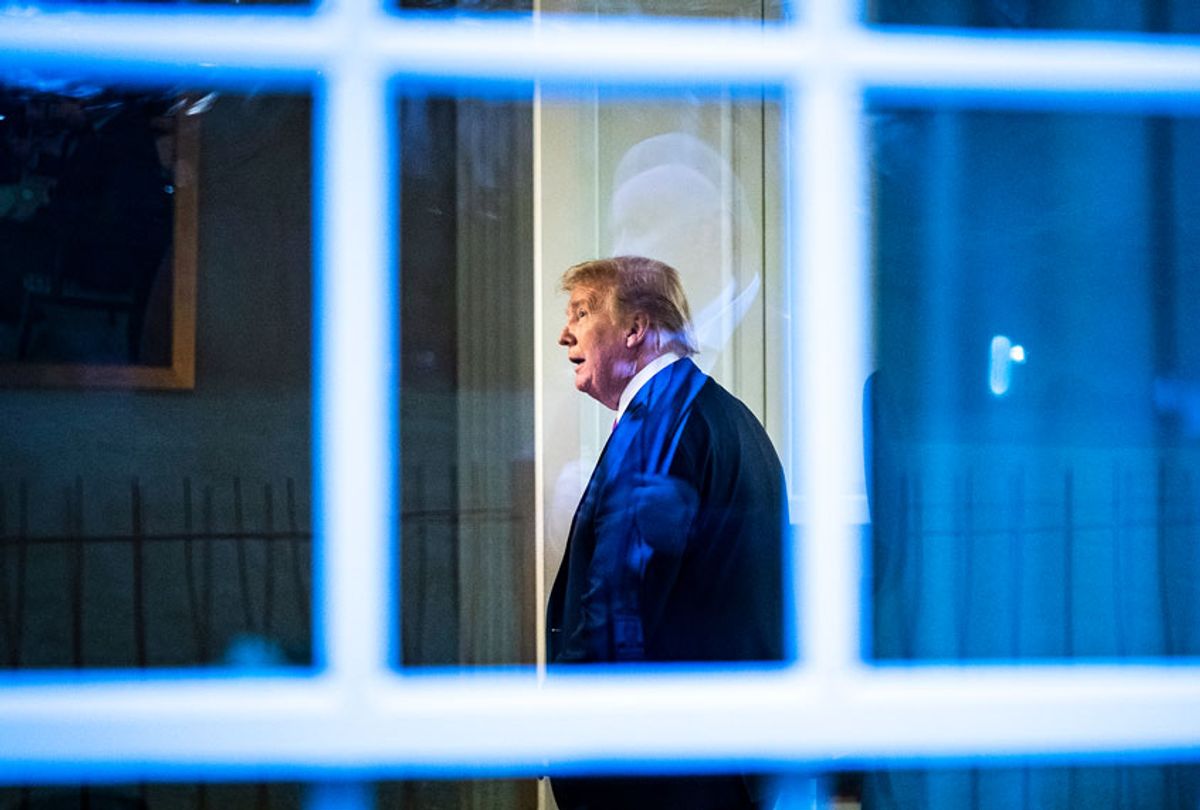 President Donald J. Trump, seen through a window, watches a television in the press office as newscasters talk about him moments after he was speaking with members of the coronavirus task force during a briefing in response to the COVID-19 coronavirus pandemic in the James S. Brady Press Briefing Room at the White House. (Jabin Botsford/The Washington Post via Getty Images)