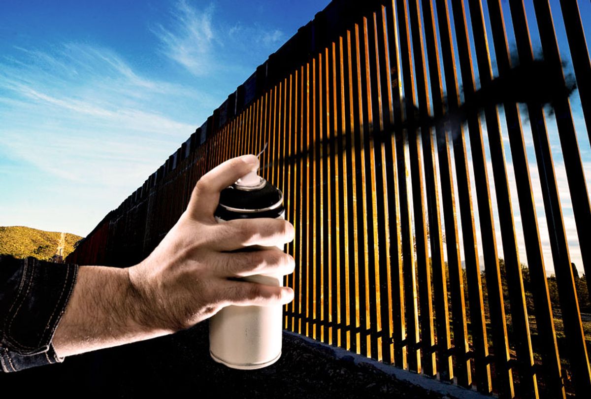 The United States-Mexico border wall spray painted black (Photo illustration by Salon/AFP/Getty Images)