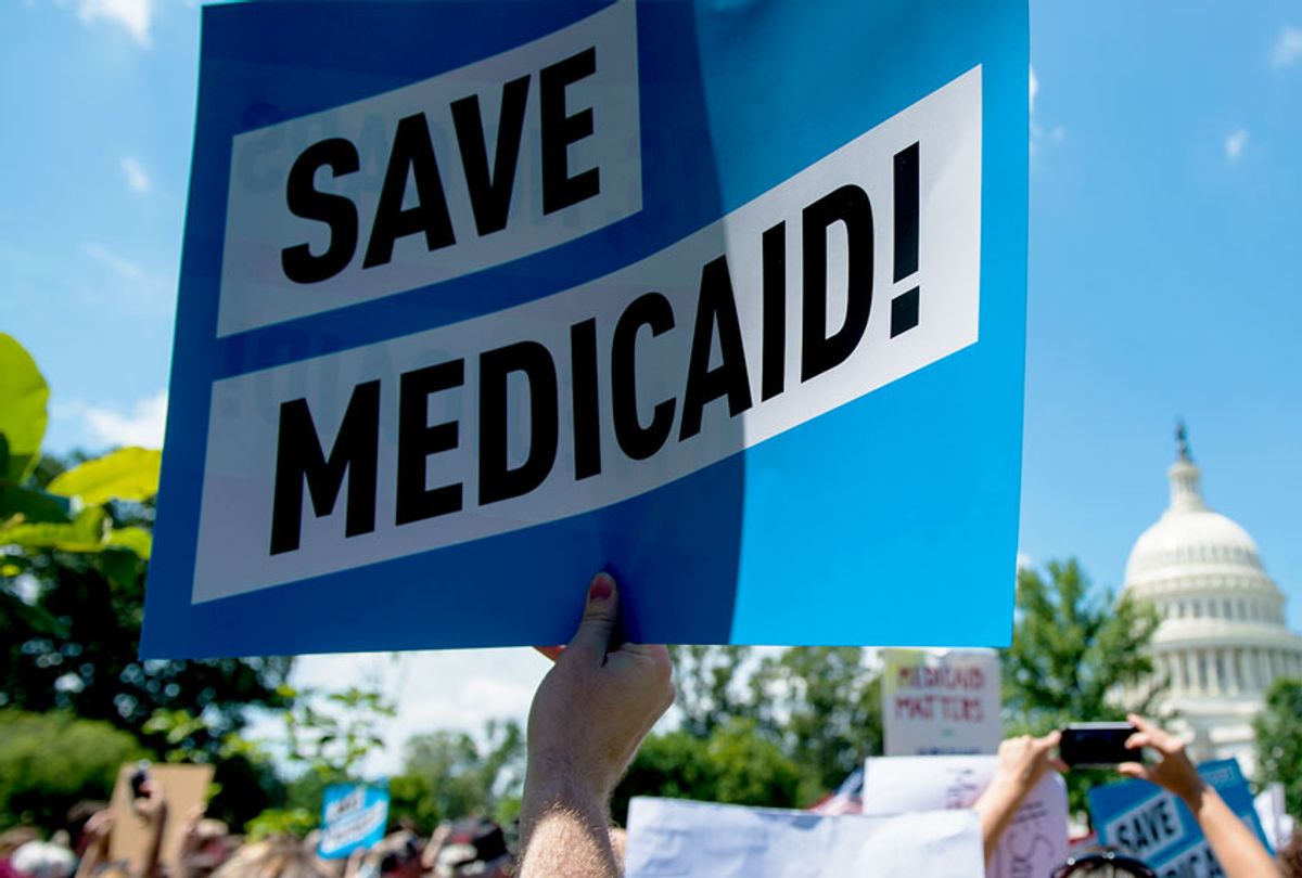 Participants hold signs during the Senate Democrats' rally against Medicaid cuts in front of the U.S. Capitol (Bill Clark/CQ Roll Call)