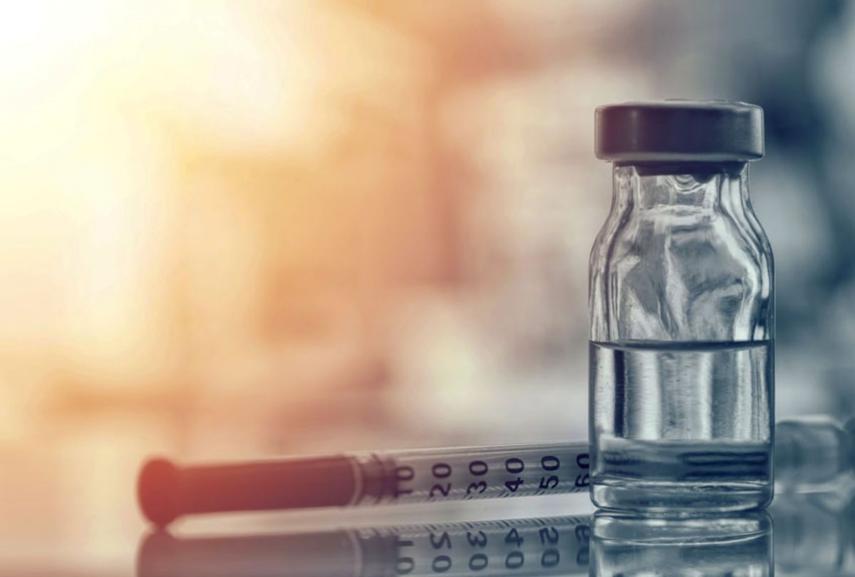 Medicine bottle with syringe and needle for immunization (Getty Images)