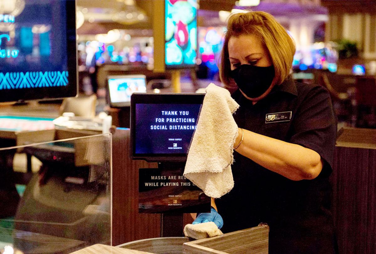 A casino employee cleans areas of the casino floor during a media tour of Bellagio hotel and casino reopening in Las Vegas, Nevada (BRIDGET BENNETT/AFP via Getty Images)