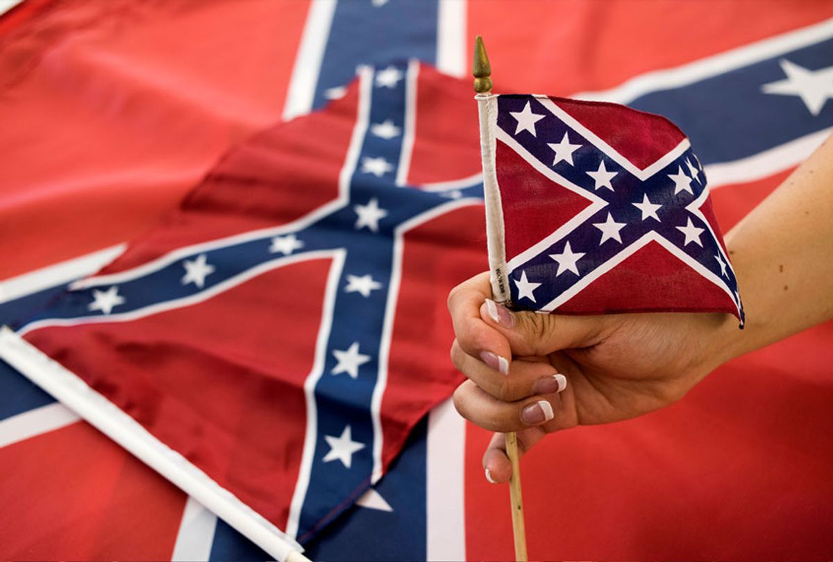 An employee holds up a Confederate flag during the manufacturing process at the Alabama Flag and Banner (Getty Images/Ty Wright)