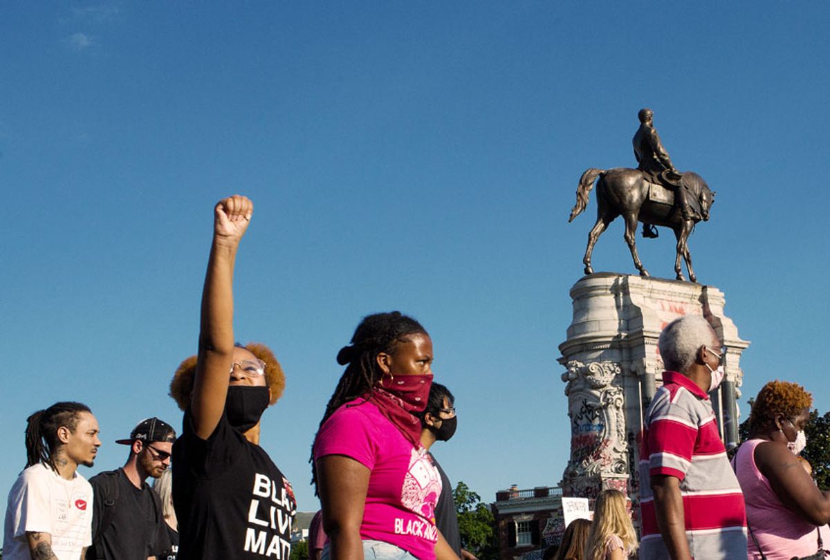 Black Lives Matter activists occupy the traffic circle underneath the statue of Confederate General Robert Lee, now covered in graffiti, on June 13, 2020 at Monument Avenue in Richmond, Virginia.  (Andrew Lichtenstein/Corbis via Getty Images)
