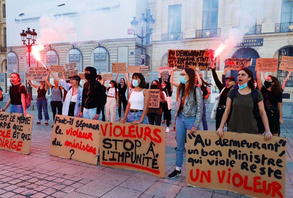 Women hold flares and placards during a protest called by "Collages Feminicides Paris" feminist organization in front of the Ministry of Justice on Place Vendome in Paris, on June 22, 2020. (FRANCOIS GUILLOT/AFP via Getty Images)