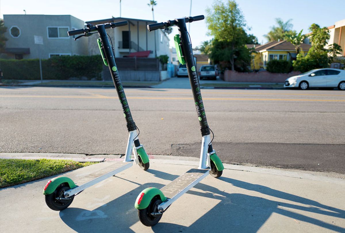 Two scooters from dockless electric scooter sharing economy company Lime are parked in a "hub" near a road in the Marina Del Rey neighborhood of Los Angeles, California (Smith Collection/Gado/Getty Images)