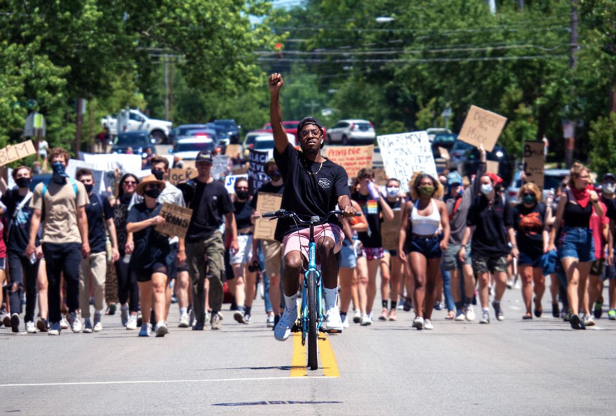 Demonstrators raise signs in the air during the Oakley Hyde Park Protest as demonstrators continue to march in protest for the 15th straight day over the murder of George Floyd and other victims of police brutality, Friday, June 12, 2020, in Cincinnati, Ohio, United States. (Jason Whitman/NurPhoto via Getty Images)