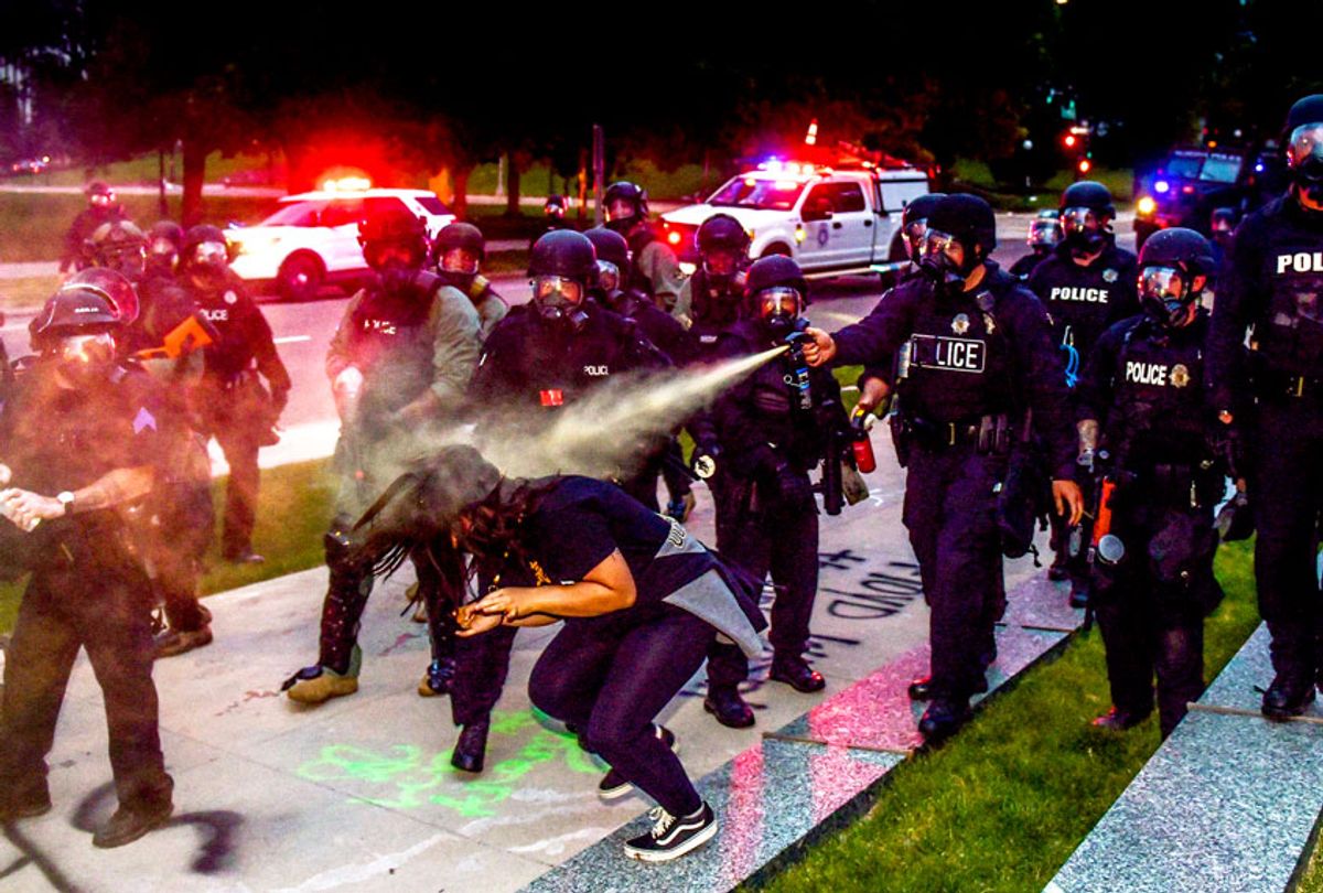 Police officers pepper spray a woman next to the Colorado State Capitol as protests against the death of George Floyd continue (Michael Ciaglo/Getty Images)