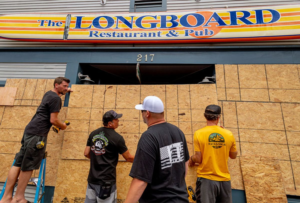 As a precaution in the event of a riot, the Longboard Restaurant & Pub is boarded up prior to a large protest (Getty Images)