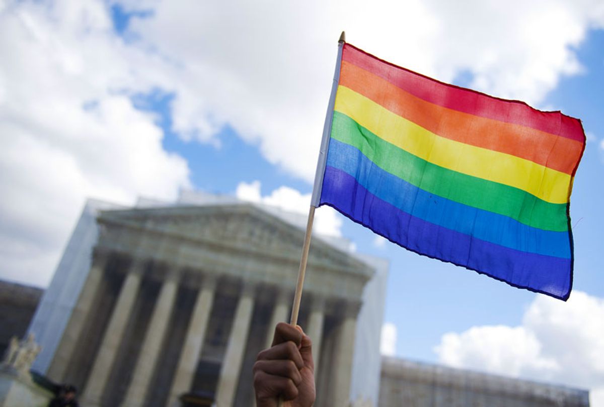 A same-sex marriage supporter waves a rainbow flag in front of the US Supreme Court  (Getty Images)