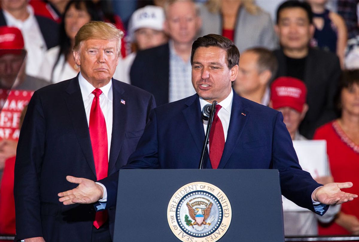 Florida Republican gubernatorial candidate Ron DeSantis speaks with U.S. President Donald Trump at a campaign rally at the Pensacola International Airport on November 3, 2018 in Pensacola, Florida.  (Mark Wallheiser/Getty Images)
