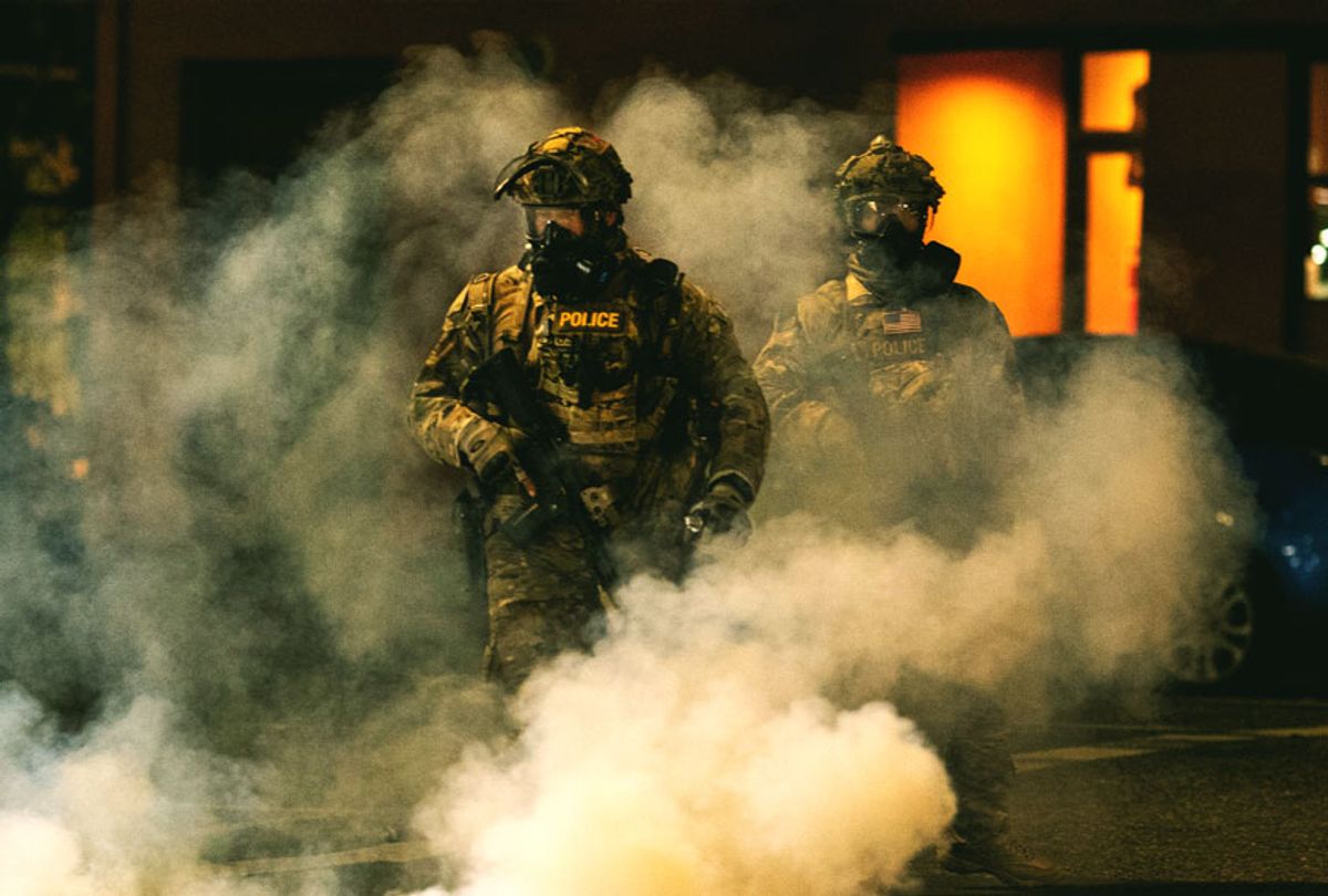 Federal officers operate amid tear gas while clearing the street in front of the Mark O. Hatfield U.S. Courthouse on July 21, 2020 in Portland, Oregon. The federal police response to the ongoing protests against racial inequality has been criticized by city and state elected officials as President Trump threatens to use Federal law enforcement in other major cities as well. (Paula Bronstein/Getty Images)