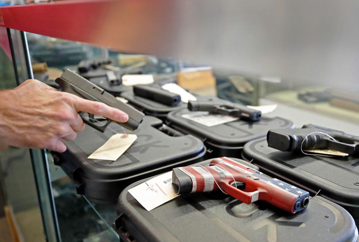 A worker restocks handguns at Davidson Defense in Orem, Utah on March 20, 2020. - Gun stores in the US are reporting a surge in sales of firearms as coronavirus fears trigger personal safety concerns. (GEORGE FREY/AFP via Getty Images)
