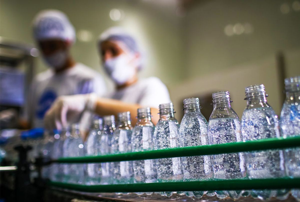 Workers in the hand sanitizer bottling process in AGE do Brasil factory on April 6, 2020, in Vinhedo, Brazil. (Buda Mendes/Getty Images)