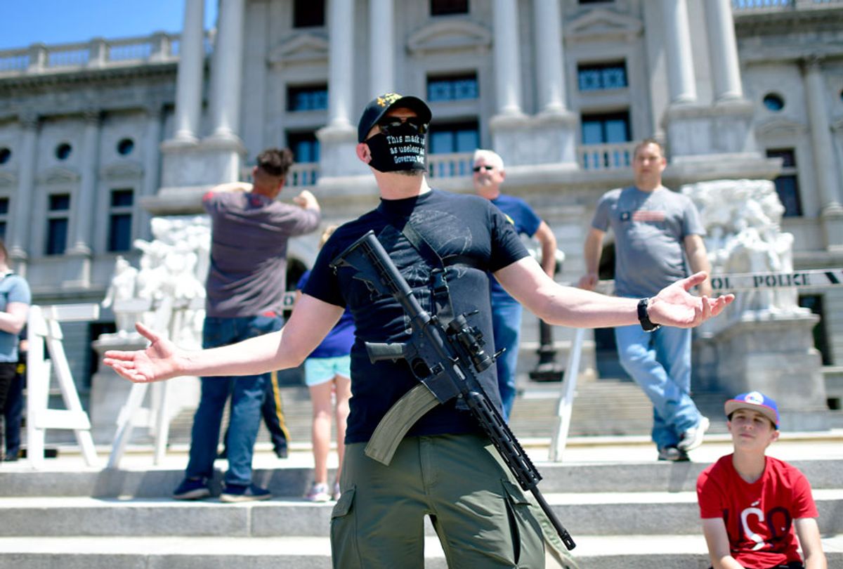 A man with an assault rifle reacts while joining demonstrators outside the Pennsylvania Capitol Building to protest the continued closure of businesses due to the coronavirus pandemic on May 15, 2020 in Harrisburg, Pennsylvania. Pennsylvania Governor Tom Wolf has introduced a color tiered strategy to reopen the state with most areas not easing restrictions until June 4. (Mark Makela/Getty Images)