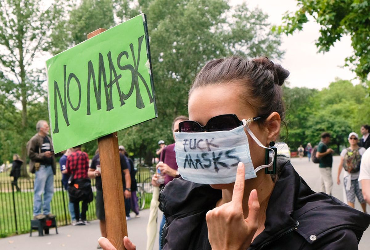 Woman protesting against the imposition of the wearing of masks (Matthew Chattle/Barcroft Media via Getty Images)