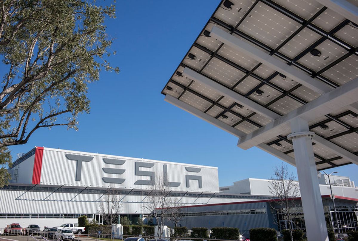 cenes at the Tesla car factory include the building's exterior with a solar panel on the property (right of frame). (David Butow/Corbis via Getty Image)