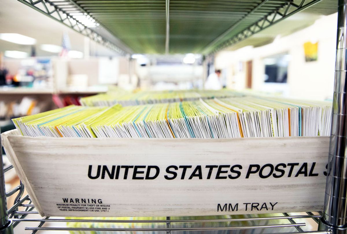 Mailed-in ballots sit in US Postal Service bins inside the office (Alex Edelman/Getty Images)