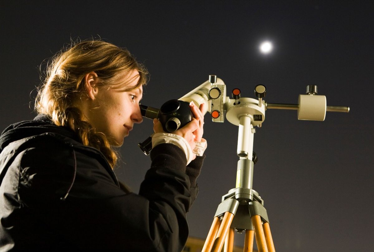 Young amateur astronomer on a school yard in Lichtenberg watching the moon with a telescope (Rolf Schulten/ullstein bild via Getty Images)
