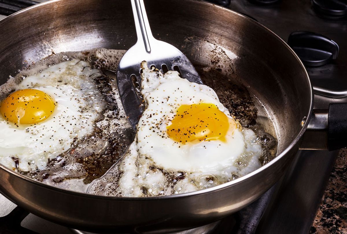 Fried Eggs In Cooking Pan On Stove (Getty Images/Tom Baker)