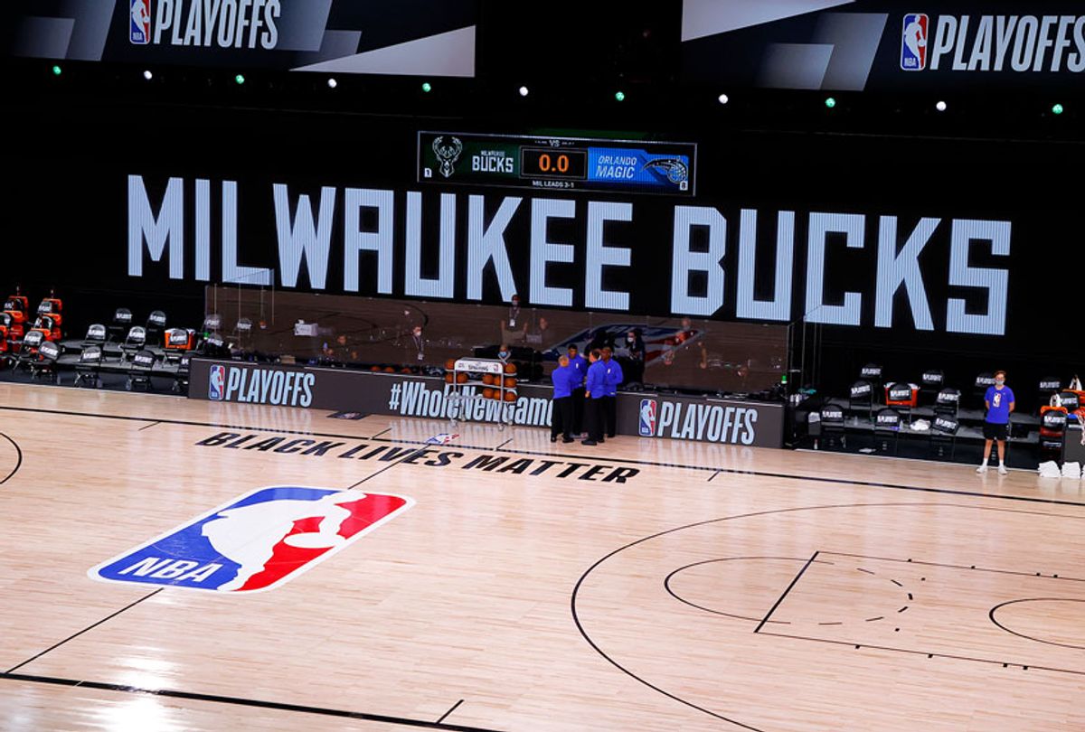 Referees huddle on an empty court at game time of a scheduled game between the Milwaukee Bucks and the Orlando Magic for Game Five of the Eastern Conference First Round during the 2020 NBA Playoffs at AdventHealth Arena at ESPN Wide World Of Sports Complex on August 26, 2020 in Lake Buena Vista, Florida. (Kevin C. Cox/Getty Images)