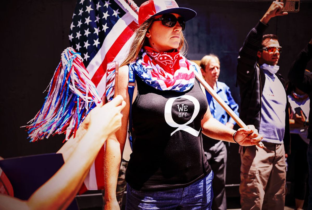 Conspiracy theorist QAnon demonstrators protest during a rally to re-open California and against Stay-At-Home directives on May 1, 2020 in San Diego, California. (SANDY HUFFAKER/AFP via Getty Images)