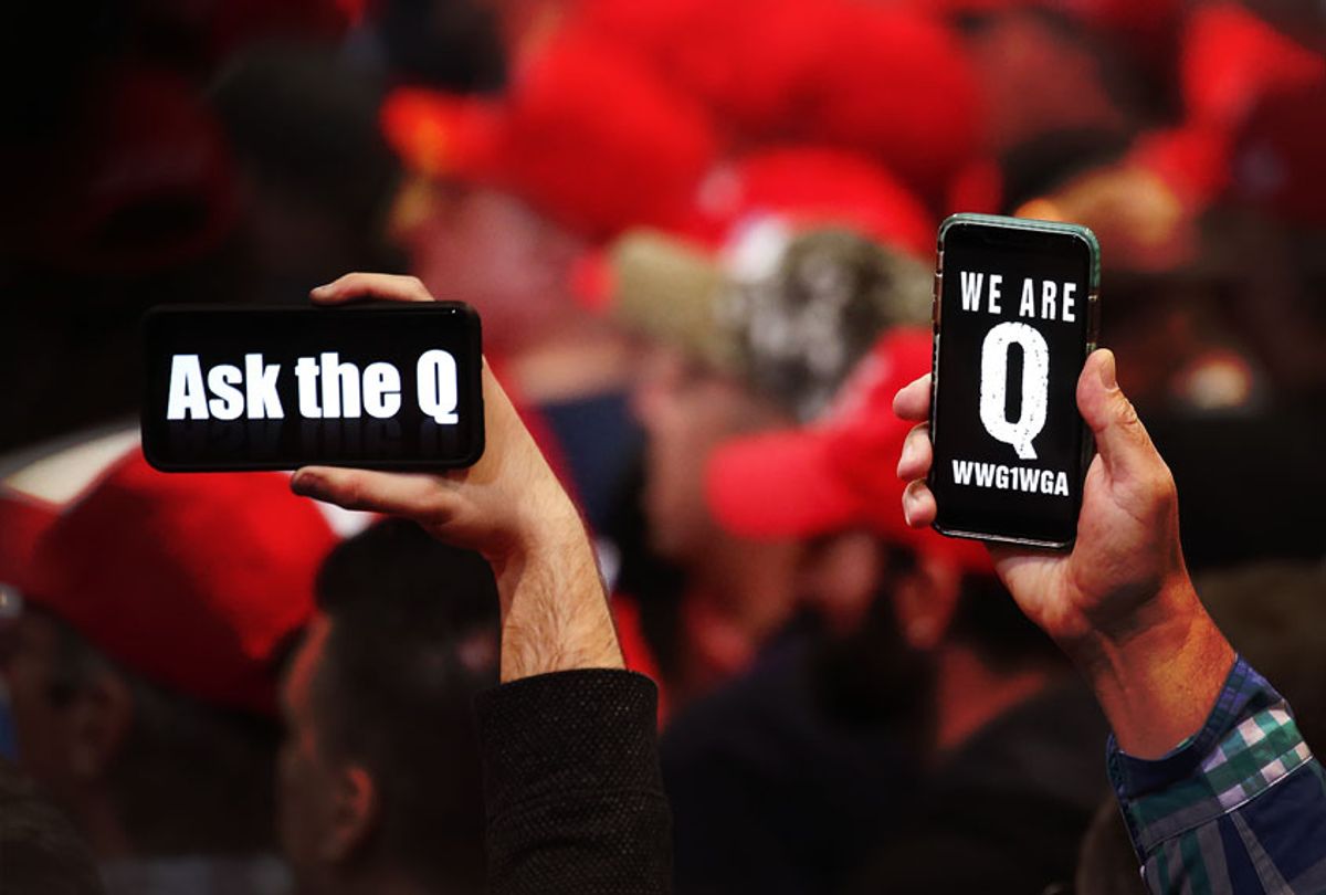 Supporters of President Donald Trump hold up their phones with messages referring to the QAnon conspiracy theory at a campaign rally at Las Vegas Convention Center on February 21, 2020 in Las Vegas, Nevada. (Mario Tama/Getty Images)