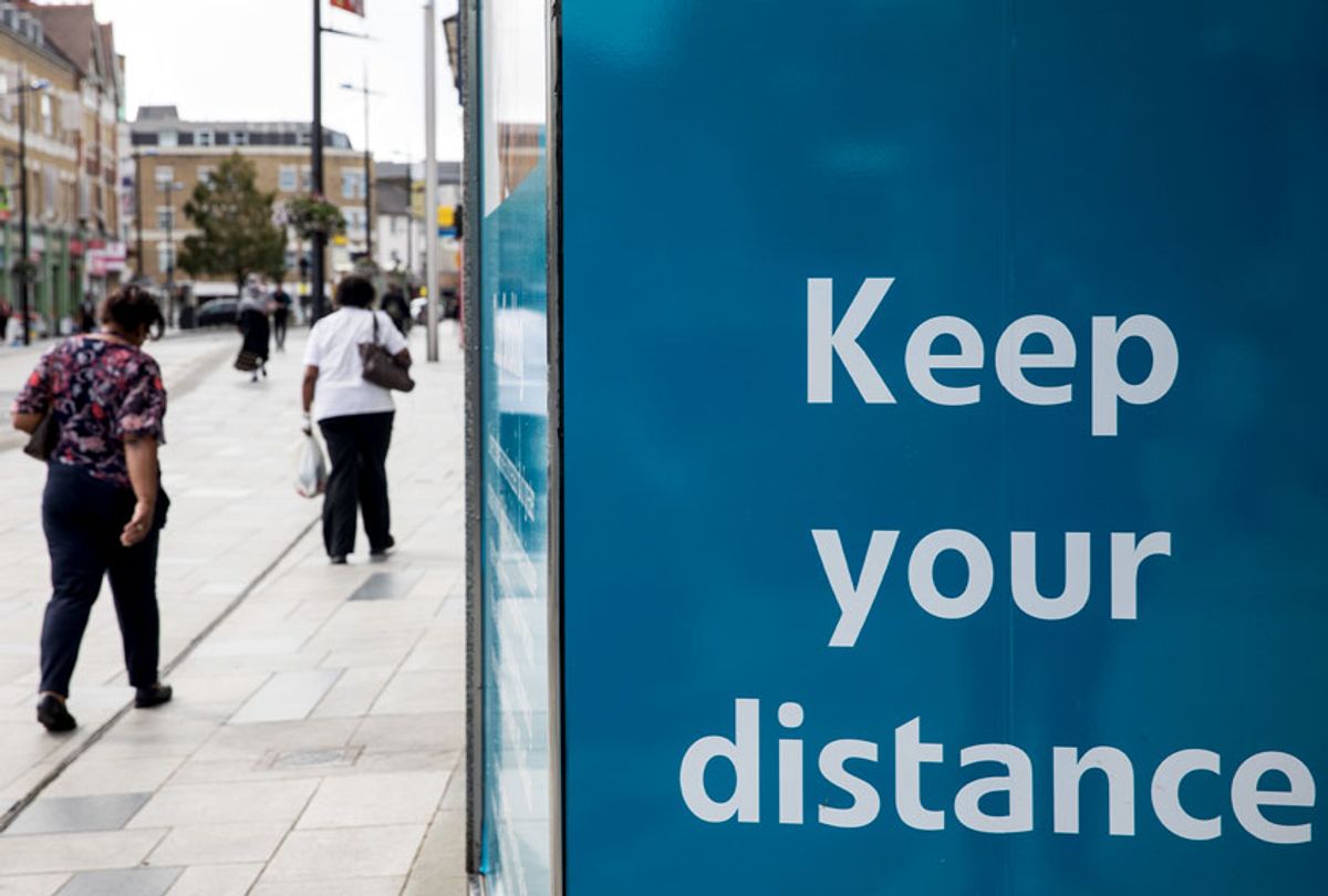 Members of the public walk past a COVID-19 social distancing display on 21st August 2020 in Slough, United Kingdom. Slough has been listed by Public Health England (PHE) and the Department for Health and Social Care (DHSC) as an area of concern for COVID-19 following a rise in positive coronavirus cases over the last two weeks. (Mark Kerrison/In Pictures via Getty Images)