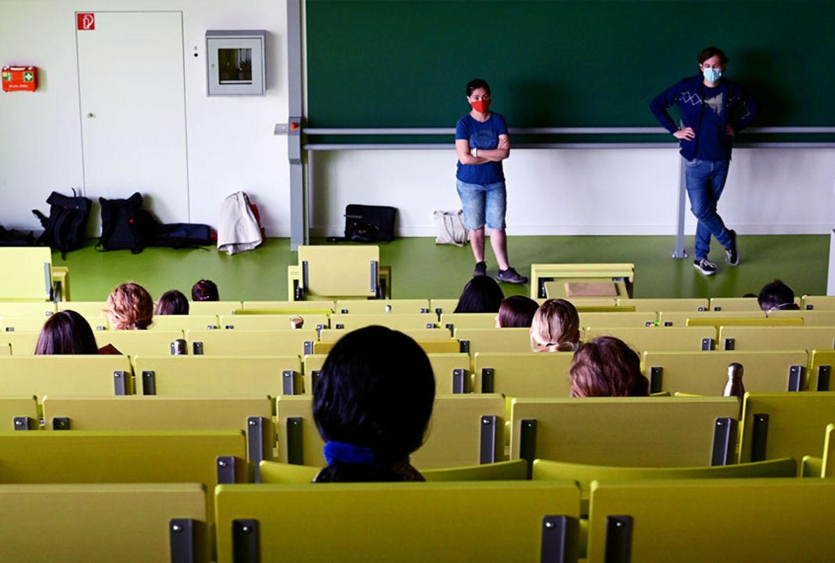 Students of economics and business studies sit in a lecture hall, observing the distance rule, and wait for the exam to begin (Getty Images)