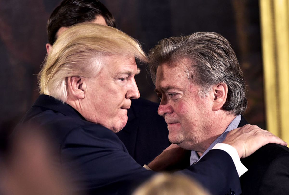 US President Donald Trump (L) congratulates Senior Counselor to the President Stephen Bannon during the swearing-in of senior staff in the East Room of the White House on January 22, 2017 in Washington, DC. (MANDEL NGAN/AFP via Getty Images)