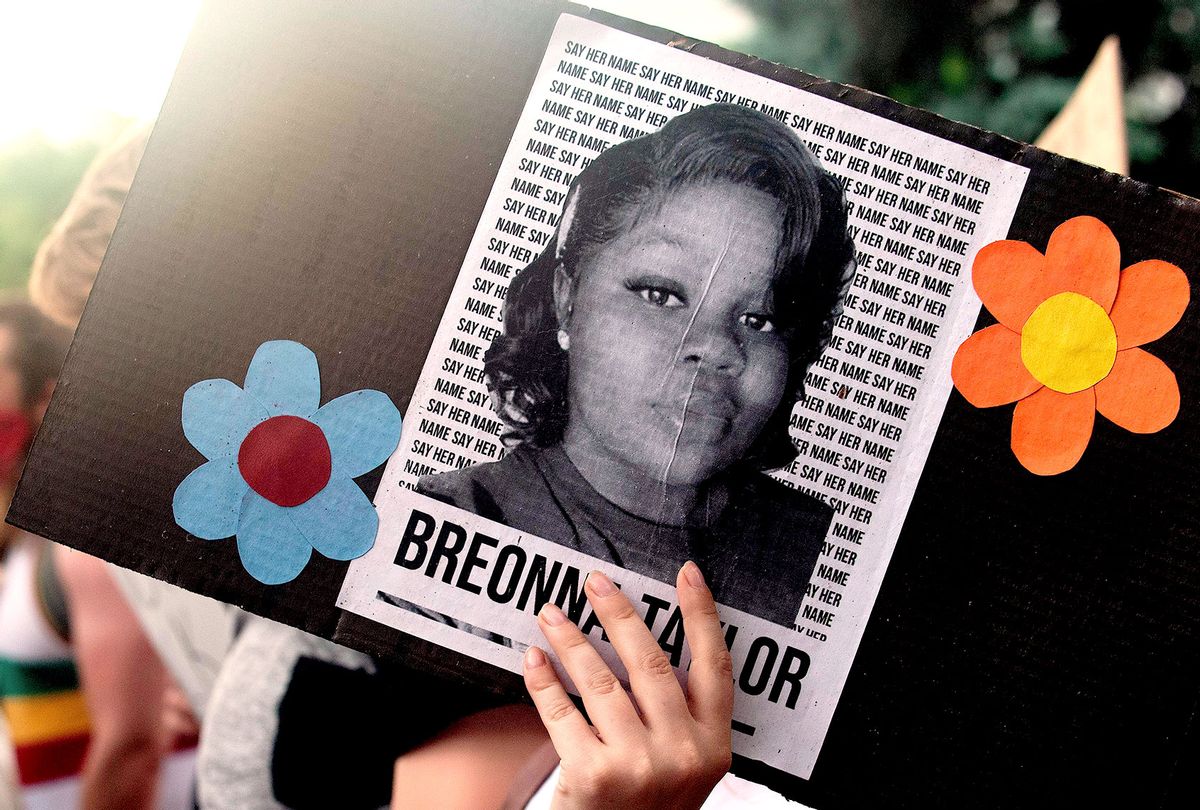 A demonstrator holds a sign with the image of Breonna Taylor, a black woman who was fatally shot by Louisville Metro Police Department officers, during a protest against the death George Floyd in Minneapolis, in Denver, Colorado on June 3, 2020. (JASON CONNOLLY/AFP via Getty Images)