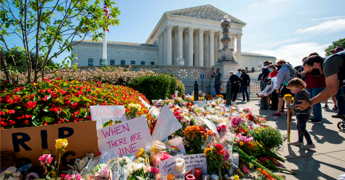 People place flowers outside the U.S. Supreme Court in memory of Justice Ruth Bader Ginsburg. Ginsburg died on Sept. 18, opening a crucial vacancy on the high court, setting off a pitched political battle at the peak of the presidential campaign (Jose Luis Magana/AFP via Getty Images)