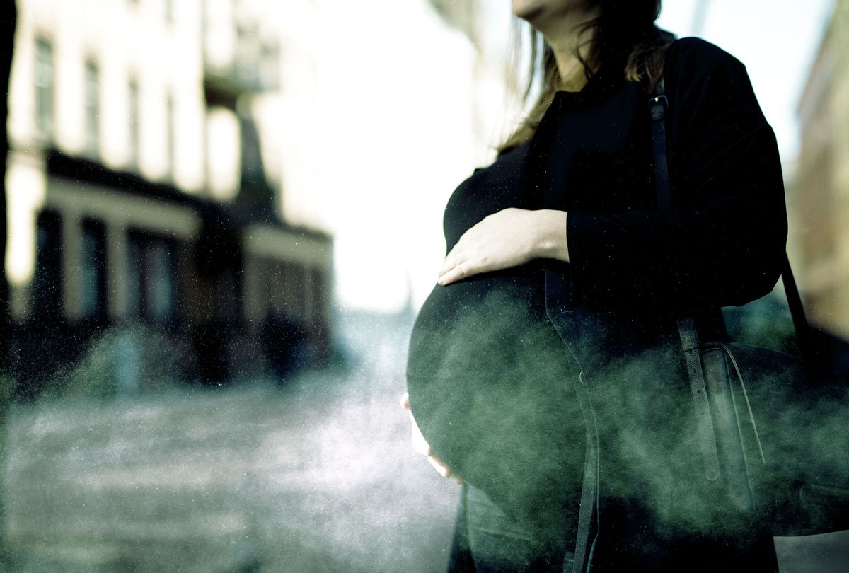 A pregnant woman surrounded by city smog (Photo illustration by Salon/Getty Images)