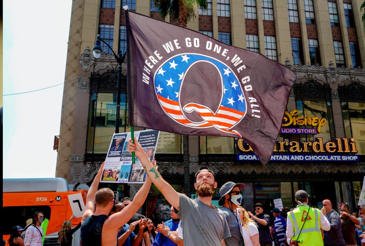 Conspiracy theorist QAnon demonstrators protest child trafficking on Hollywood Boulevard in Los Angeles, California, August 22, 2020. - A 2019 bulletin from the FBI warned that conspiracy theory-driven extremists are a domestic terrorism threat. (KYLE GRILLOT/AFP via Getty Images)
