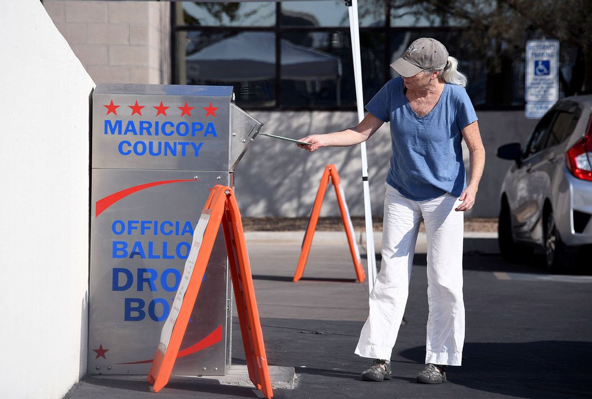 People deposit their mail-in ballots for the US presidential election at a ballot collection box in Phoenix, Arizona on October 18, 2020. (Joe Raedle/Getty Images)