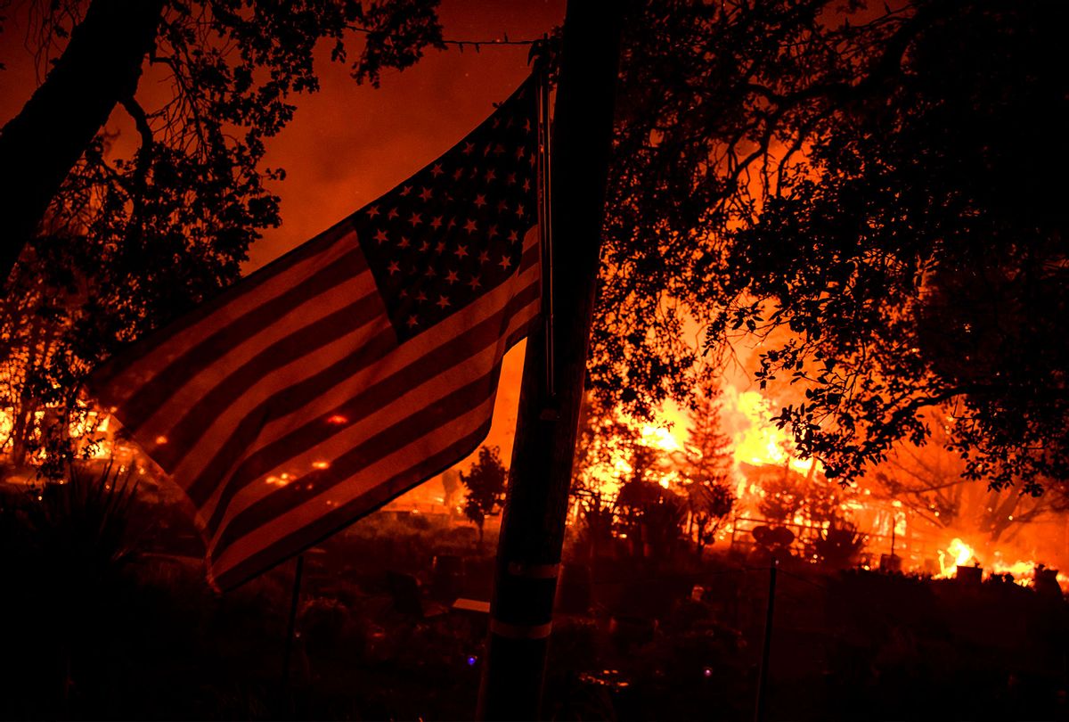 Buildings burn along Highway 12 from the Shady Fire as it approaches Santa Rosa, California on September 28, 2020. - The wildfire quickly spread over the mountains and reached Santa Rosa where is has begun to affect homes. (SAMUEL CORUM/Agence France-Presse/AFP via Getty Images)