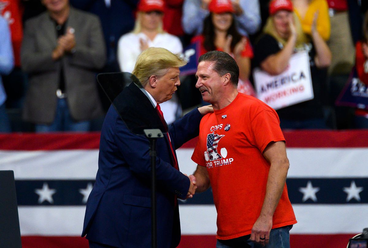 U.S. President Donald Trump shakes hands with Minneapolis Police Union head Bob Kroll on stage during a campaign rally at the Target Center on October 10, 2019 in Minneapolis, Minnesota. The rally follows a week of a contentious back and forth between President Trump and Minneapolis Mayor Jacob Frey. (Stephen Maturen/Getty Images)