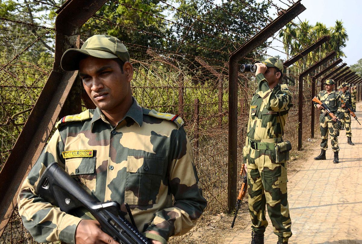 Indian Border Security Force (BSF) personnel keep a vigil near India-Bangladesh fencing border during a patrol ahead of India's 70th Republic Day celebration at Lankamura village, on the outskirts of Agartala, the capital of northeastern state of Tripura on January 24, 2019. (ARINDAM DEY/AFP via Getty Images)