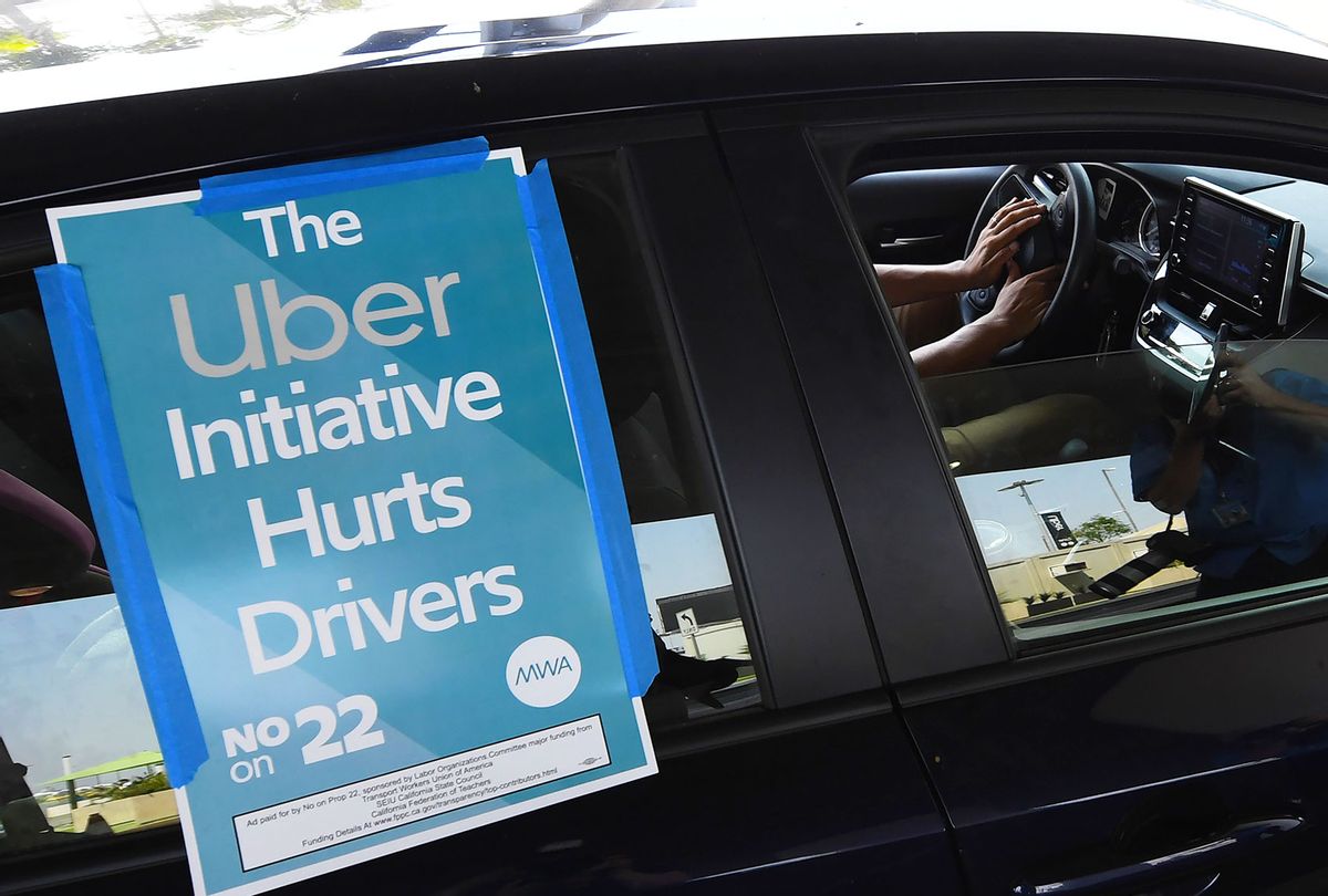 A ride share driver participates in a protest by drivers and their supporters, August 20, 2020 at Los Angeles International Airport in Los Angeles, California. - Rideshare service rivals Uber and Lyft were given a temporary reprieve on August 20 from having to reclassify drivers as employees in their home state of California by August 21. (ROBYN BECK/AFP via Getty Images)