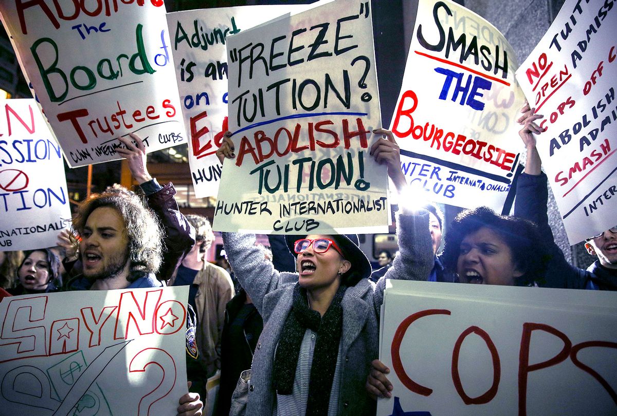 Students hold placards as they stage a demonstration at the Hunter College, which is a part of New York City University, to protest ballooning student loan debt for higher education and rally for tuition-free public colleges in New York on November 13, 2015. (Cem Ozdel/Anadolu Agency/Getty Images)