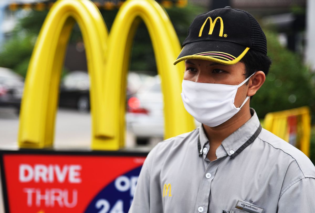 An employee of McDonald's wearing a protective mask as a precaution during the Covid-19 pandemic. (Getty Images)