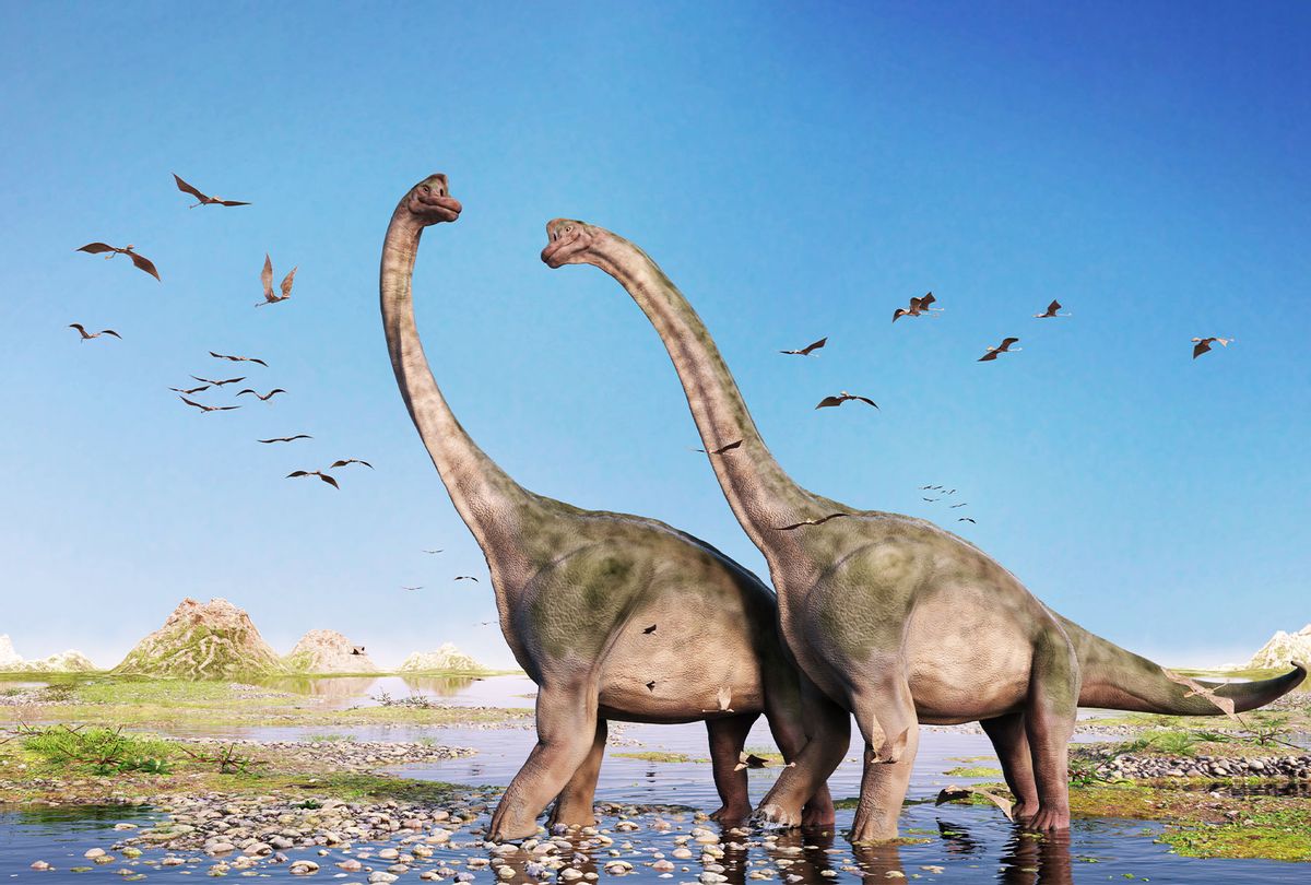 Pair of giant sauropods walking through water and a swarm of flying pterosaurs (Getty Images)