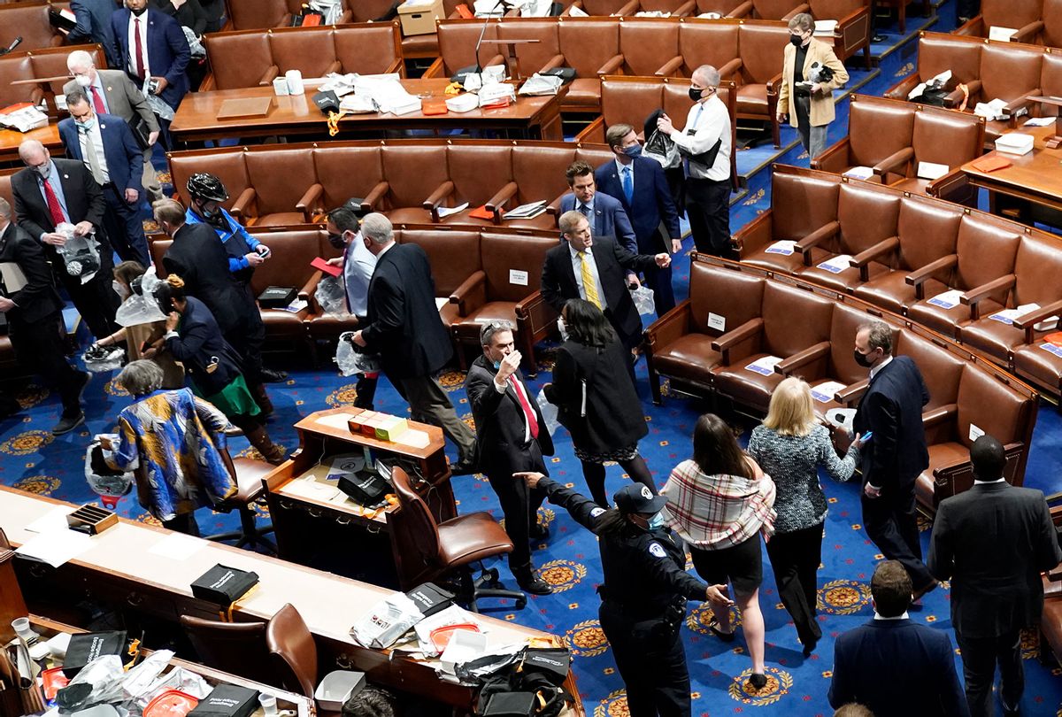 Members of Congress evacuate the House Chamber as protesters attempt to enter during a joint session of Congress on January 06, 2021 in Washington, DC. Congress held a joint session today to ratify President-elect Joe Biden's 306-232 Electoral College win over President Donald Trump. A group of Republican senators said they would reject the Electoral College votes of several states unless Congress appointed a commission to audit the election results. Pro-Trump protesters entered the U.S. Capitol building after mass demonstrations in the nation's capital. (Drew Angerer/Getty Images)