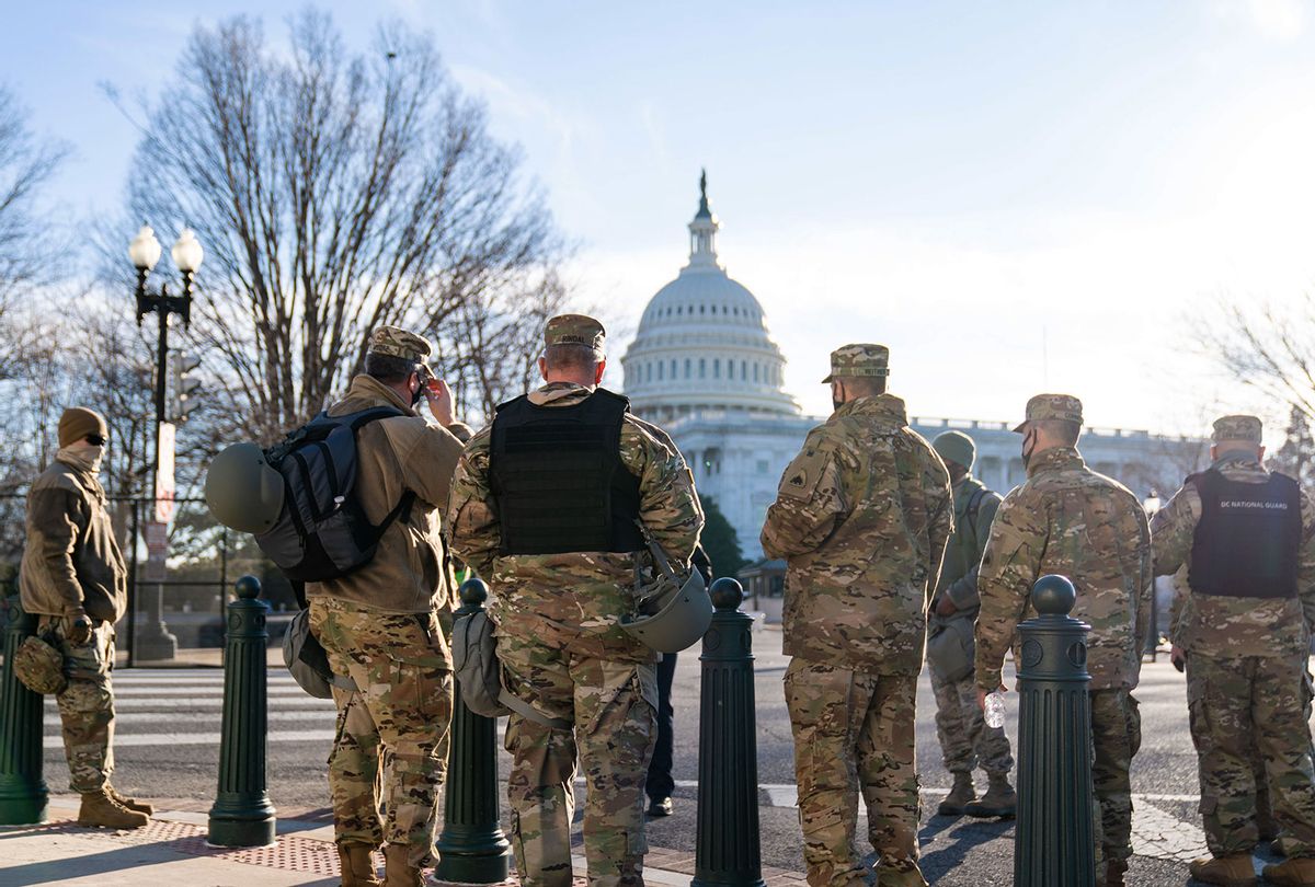 Members of the National Guard stand across the street near the Senate office buildings with the U.S. Captiol in the background as heightened security measures are put in place around the U.S. Capitol Building a day after a pro-Trump mob broke into the nations capitol while Congress voted to certify the 2020 Election Results on Thursday, Jan. 7, 2021 in Washington, DC. (Kent Nishimura / Los Angeles Times via Getty Images)